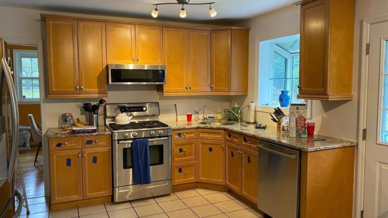He Spray Painted the Orange Oak Cabinets Into a Two-Tone Design and the Kitchen Took on a Custom-Built Look
