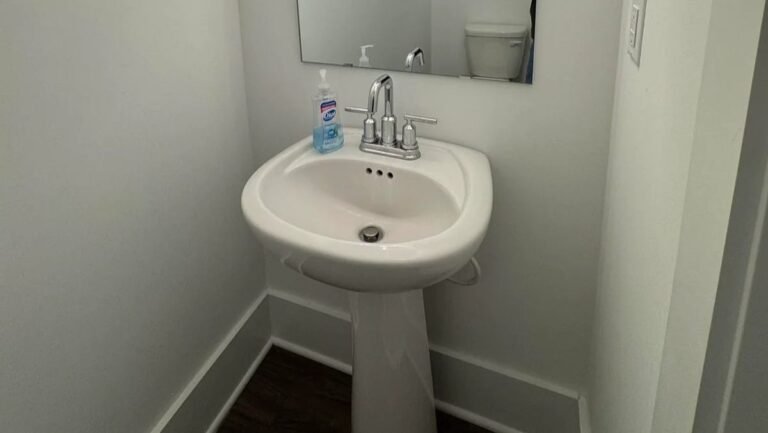 Picture Frame Molding Turned This Builder-Grade Powder Room Into a Designer Bathroom
